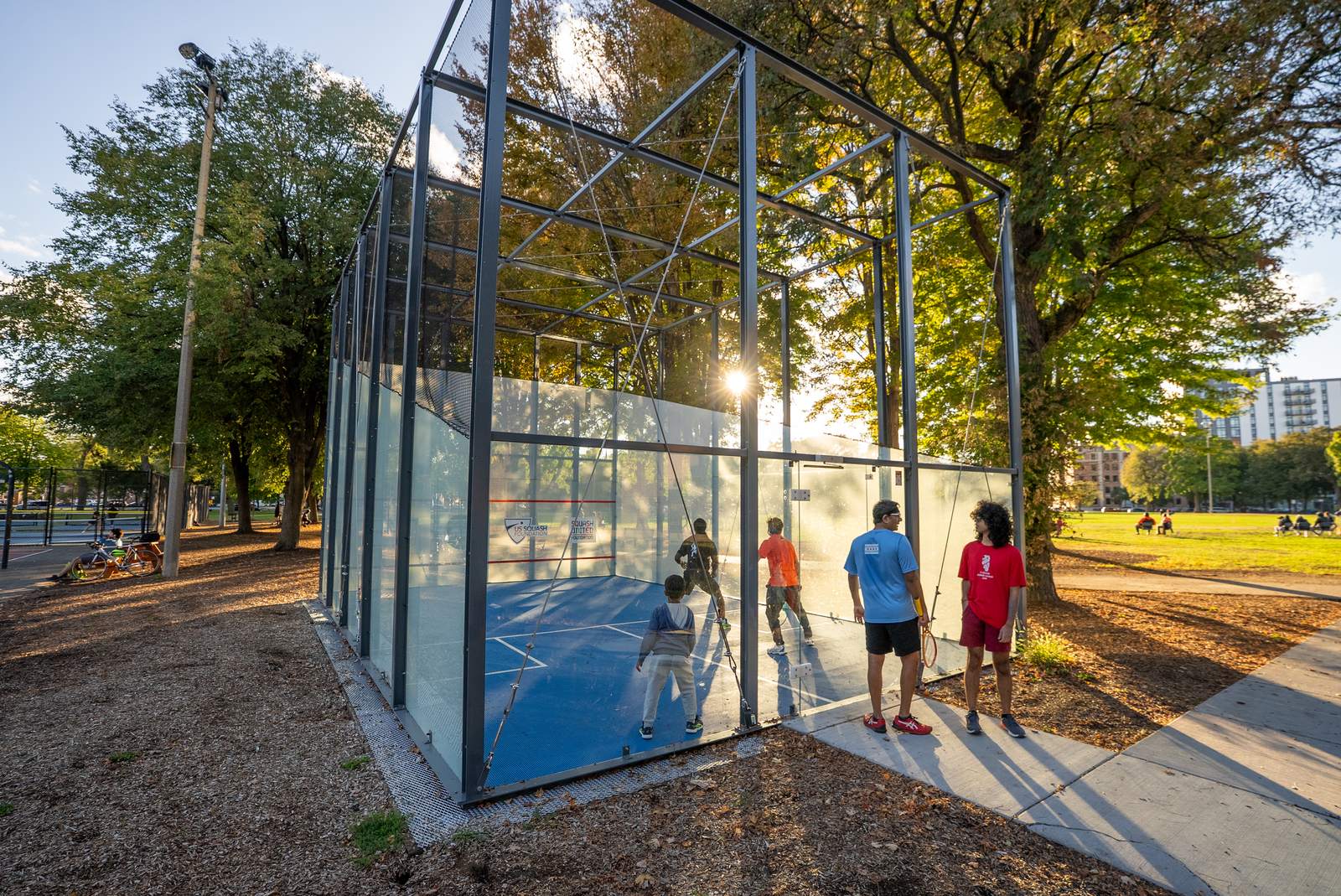 Outdoor glass squash court in a public park